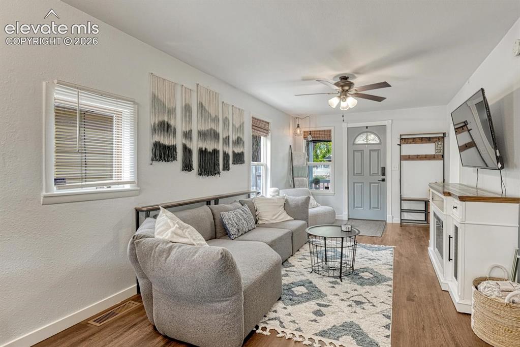 Image 6 of 21: Living space featuring luxury vinyl plankingm white walls, and recessed lig