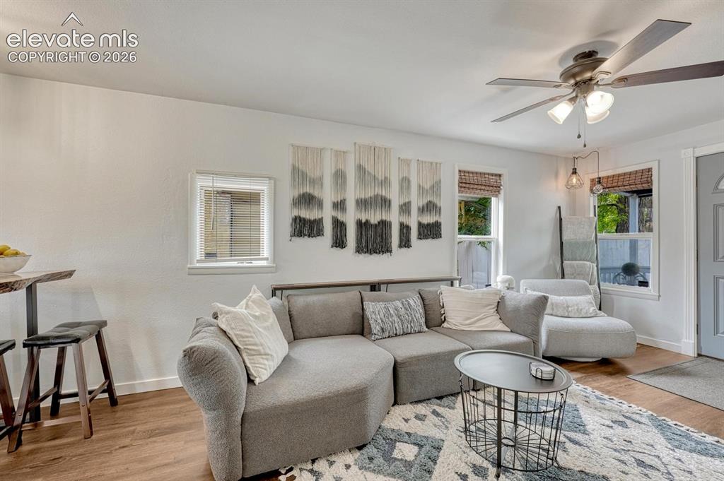 Image 7 of 21: Living area featuring luxury vinyl plank flooring, white walls, and a ceili