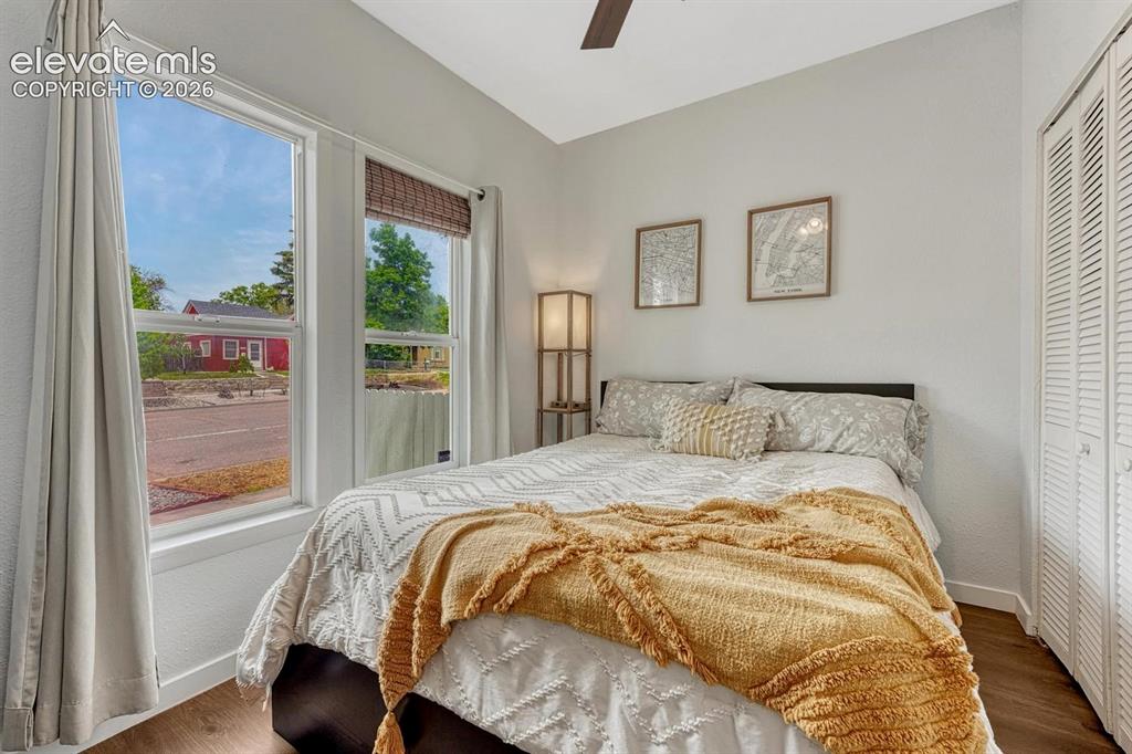 Image 8 of 25: Wood-finish flooring, white walls, and a ceiling fan with integrated lighti