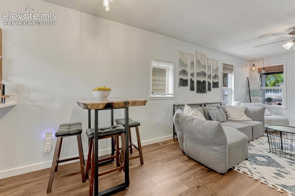 Image 9 of 21: Open-concept living area featuring white walls, and multiple windows with b