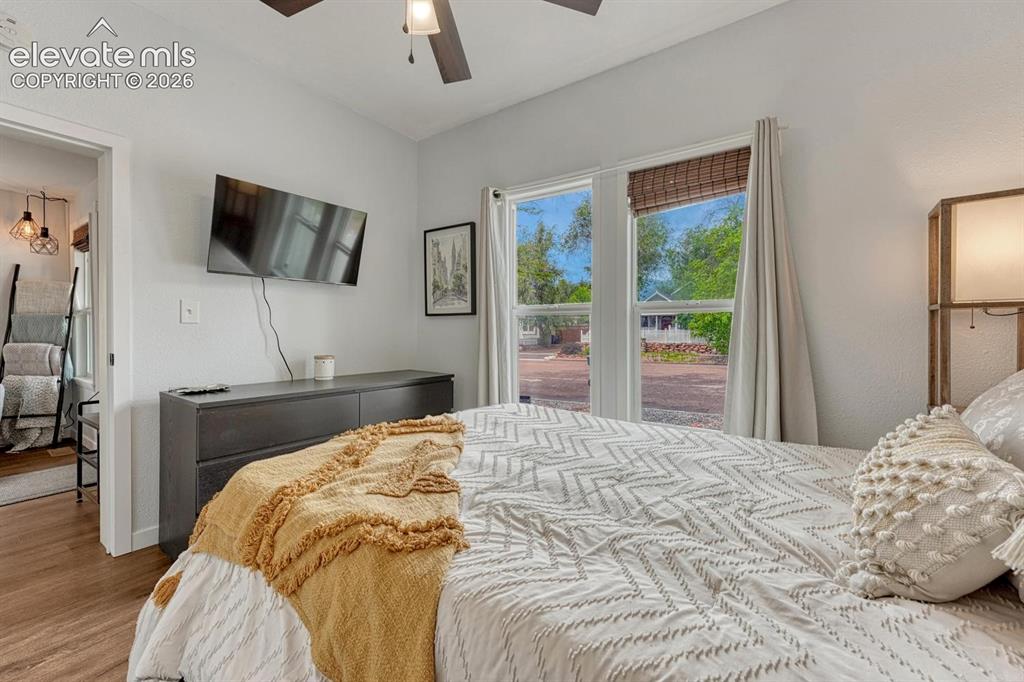 Image 9 of 25: bright and sunny with ceiling fan, wood-finish flooring, white walls, and a
