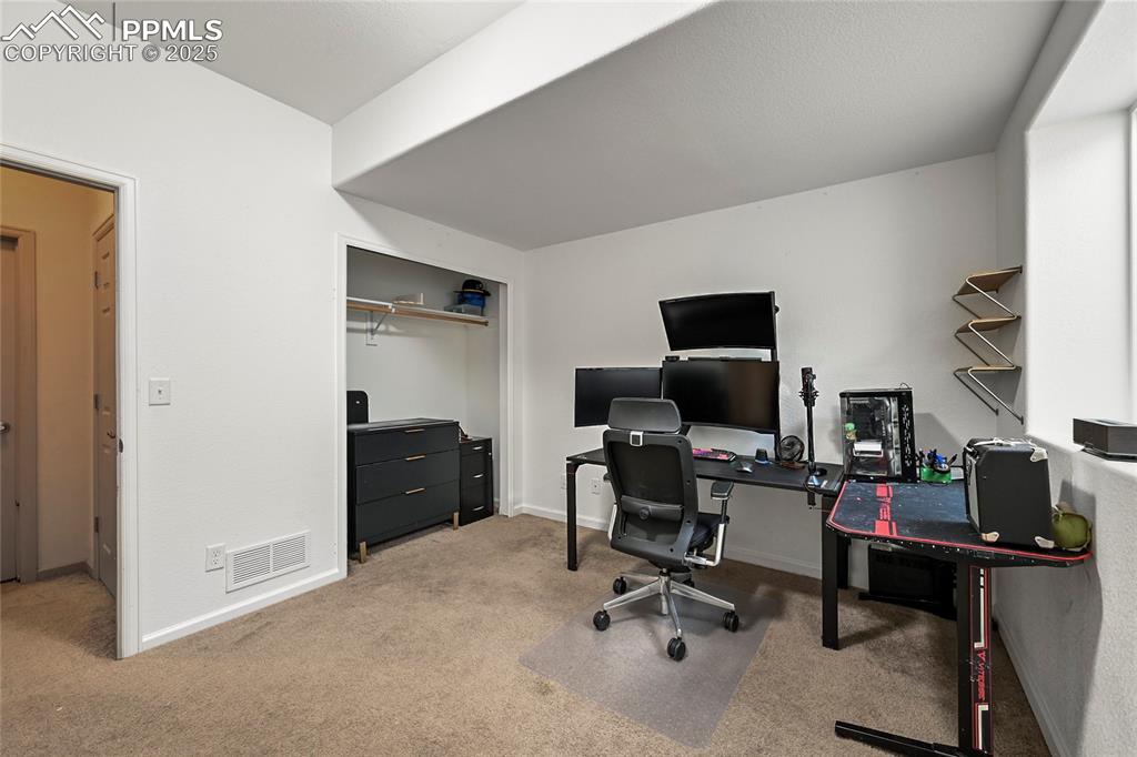 Image 19 of 22: Office area featuring visible vents, carpet flooring, and baseboards