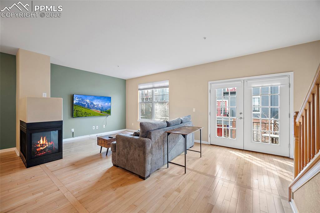 Image 16 of 49: Three-sided fireplace and walk out to Balcony!  