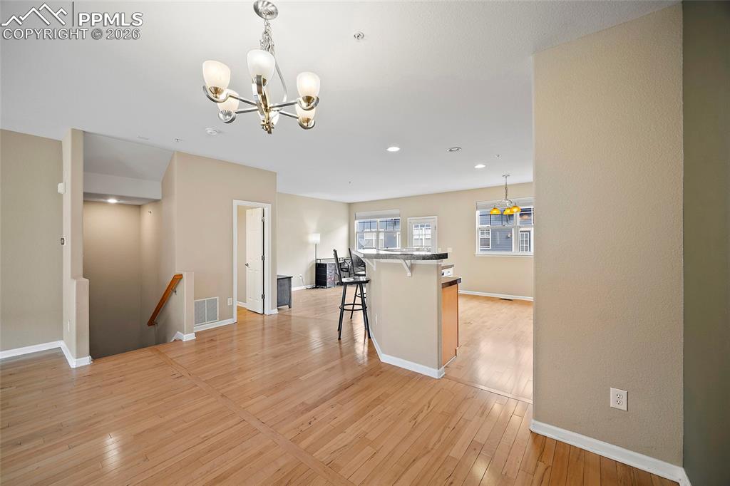 Image 21 of 49: Gorgeous wood floors on this level. 