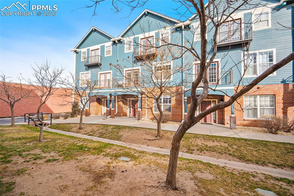 Image 3 of 49: Outside your front door is a grassy area for play and walking your pets.  