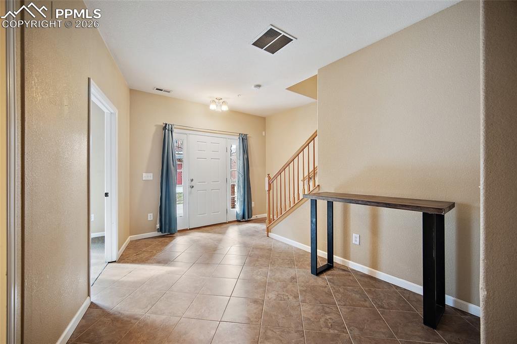 Image 7 of 49: Front entry tile way. 