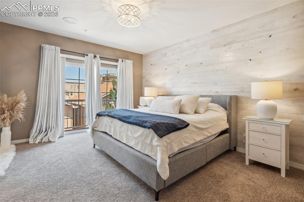 Image 19 of 49: Upper Level Primary Suite with Patio Access