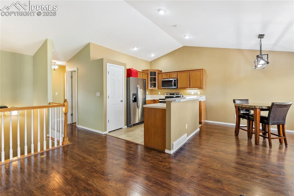 Image 10 of 36: Kitchen with glass insert cabinets, wood finish cabinetry, stainless steel