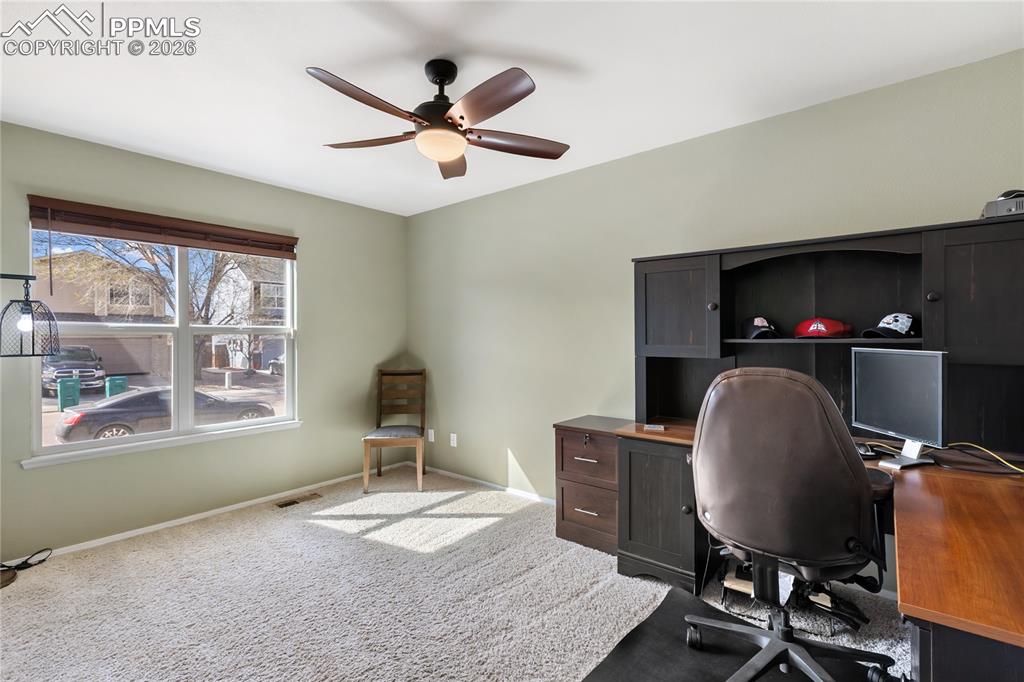 Image 28 of 36: Carpeted office with ceiling fan and baseboards