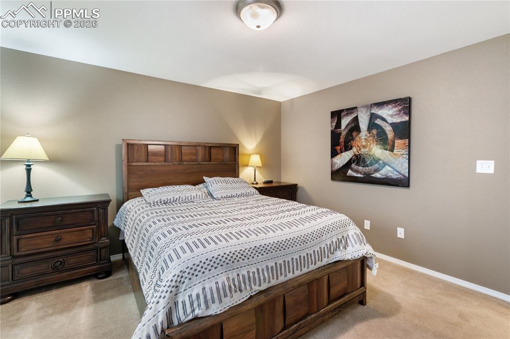 Image 30 of 36: Bedroom featuring light colored carpet and baseboards