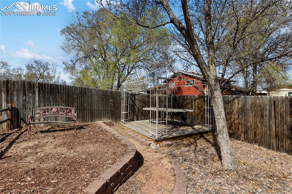 Image 5 of 36: View of fenced backyard