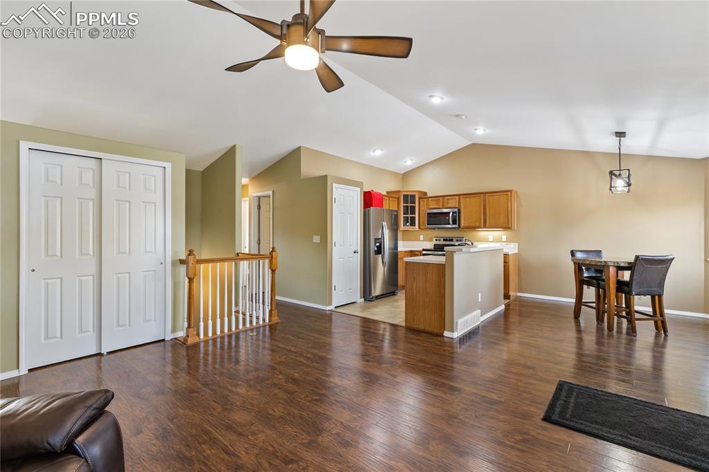 Image 9 of 36: Kitchen featuring open floor plan, glass insert cabinets, wood finish cabin
