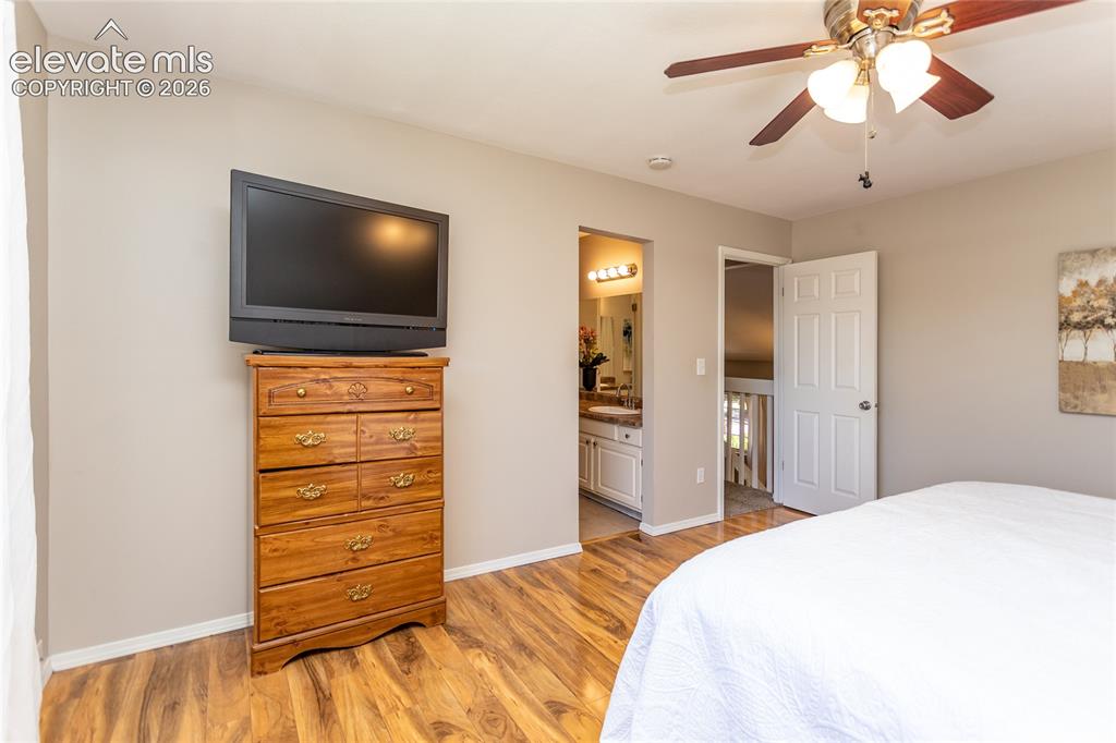 Image 14 of 40: Primary bedroom has access to private vanity.