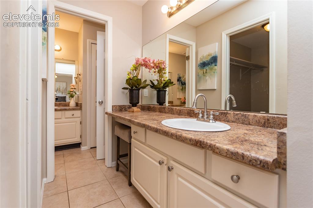 Image 15 of 40: Private vanity, sink and walk-in closet.