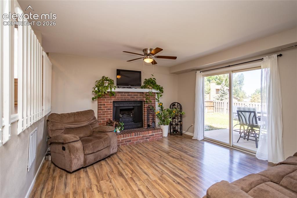 Image 21 of 40: Lower level family room with walkout to patio and lower deck.