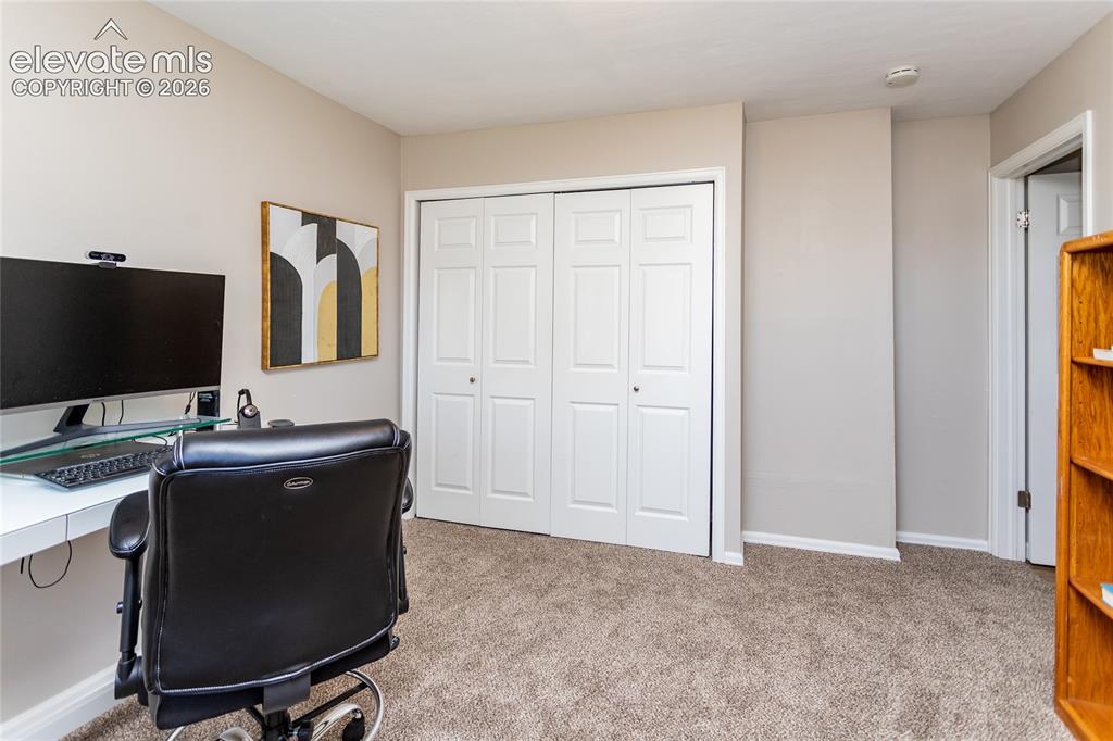 Image 24 of 40: Lower level bedroom being used as an office.