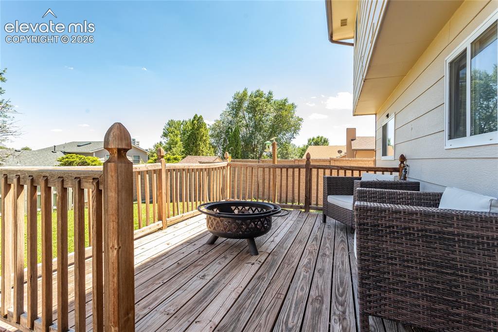 Image 28 of 40: Back yard deck outside family room.