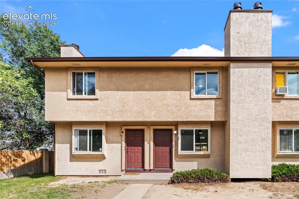Image 1 of 35: Two-story exterior with stucco finish, brown gutters, and multiple windows
