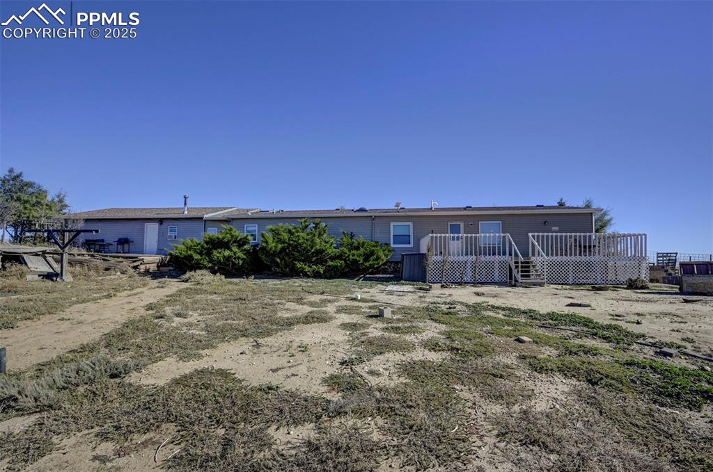 Image 31 of 31: Back of property with a wooden deck