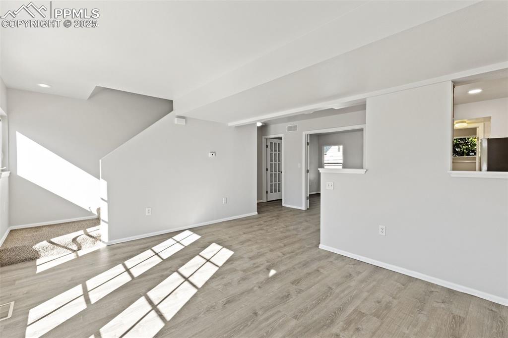 Image 11 of 34: Tons of Natural Light in the Open Concept Living Room, Dining Area, and Kit