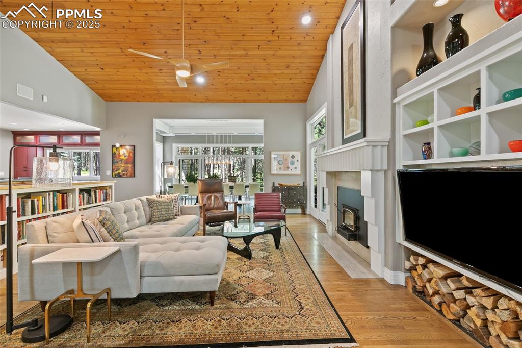 Image 6 of 50: Great Room with vaulted ceilings and wood insert