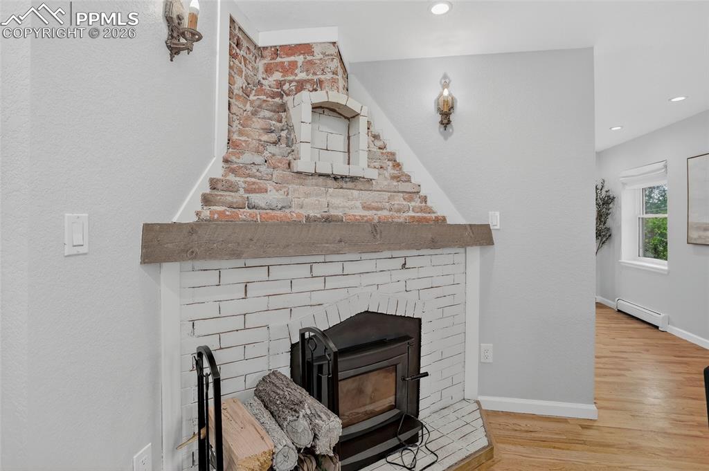 Image 18 of 49: Gorgeous original wood-burning fireplace