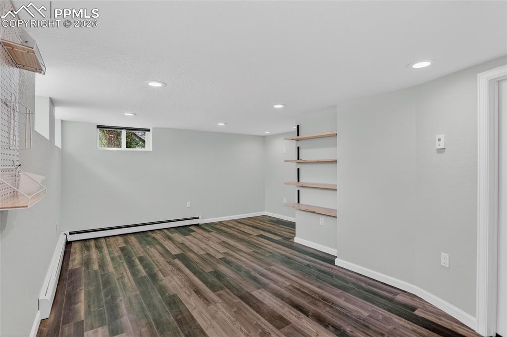 Image 29 of 49: Basement family room with LVP flooring