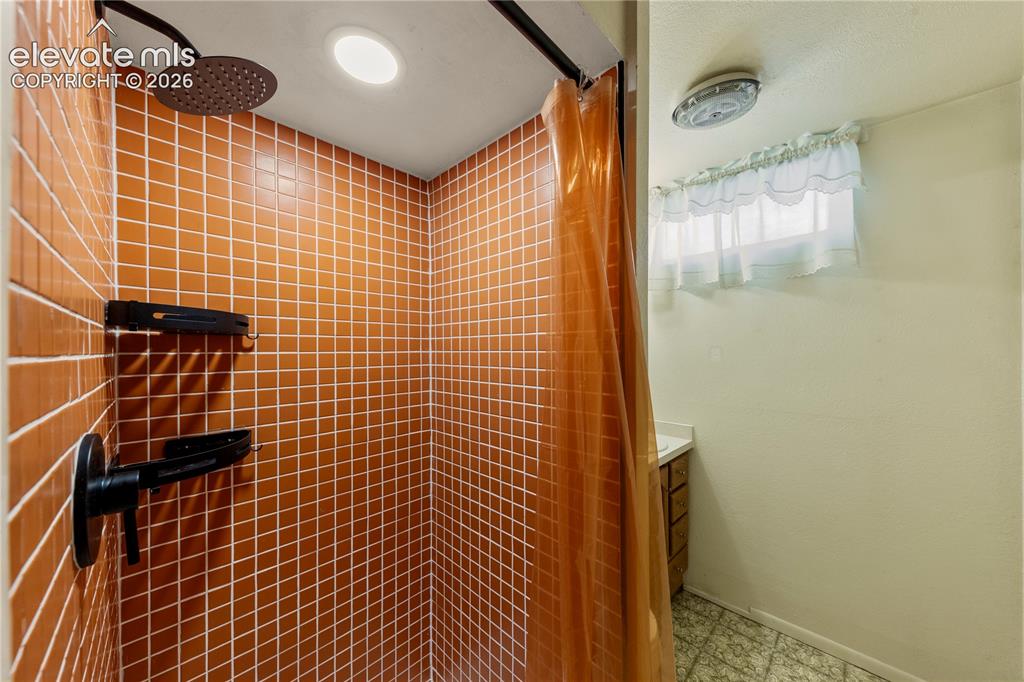 Image 10 of 49: Remodeled Basement Bathroom