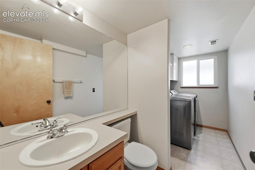 Image 13 of 35: 1/2 bath & laundry off the family room