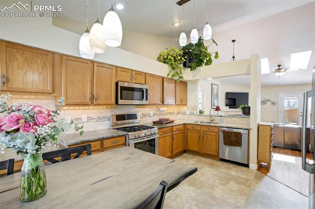 Image 13 of 50: Enjoy casual dining with views of the outdoors, complemented by contemporar