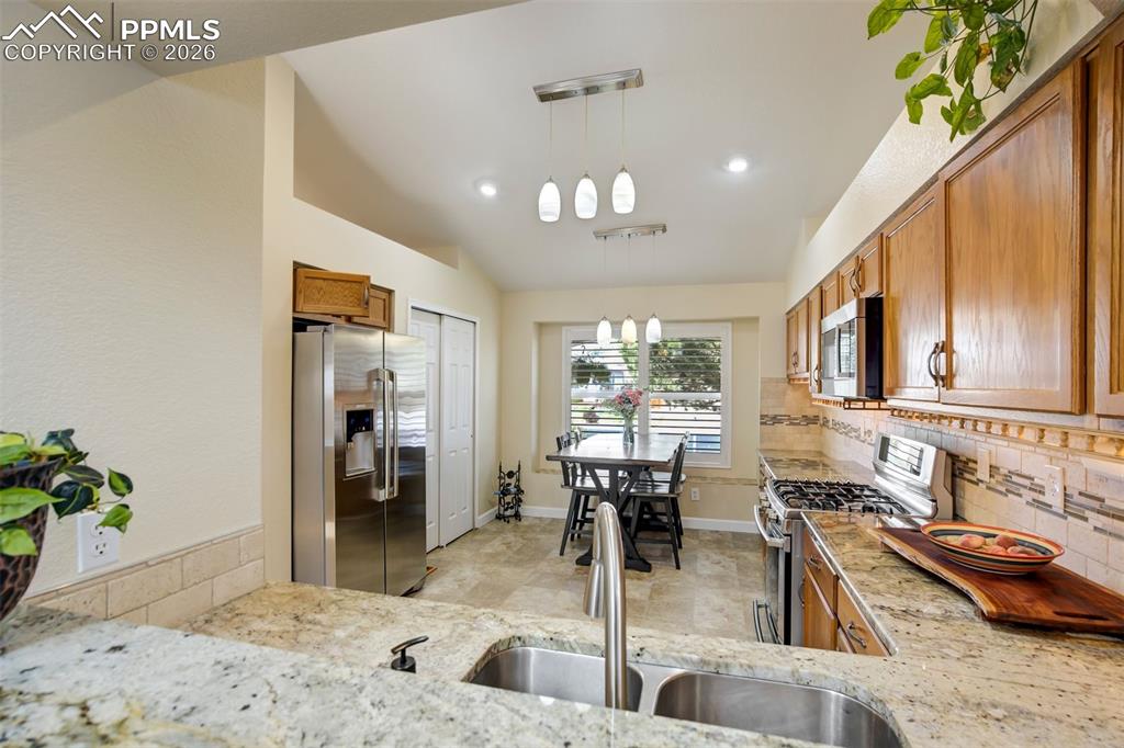 Image 14 of 50: This well-appointed kitchen features granite countertops, abundant cabinetr