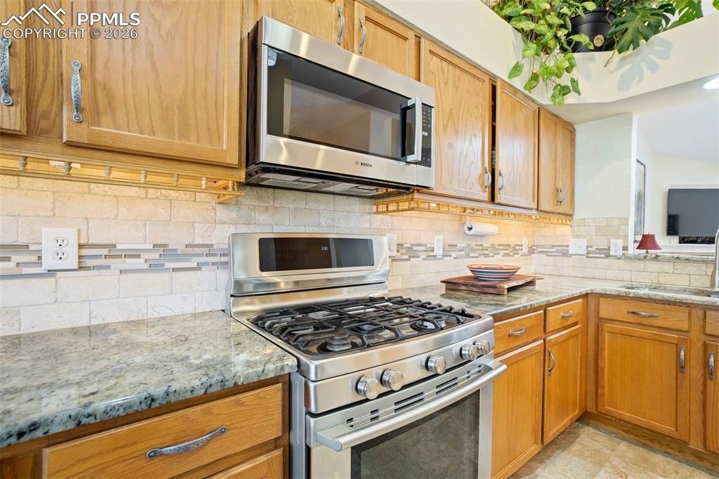 Image 16 of 50: The kitchen offers a convenient pass-through to the living area, keeping yo