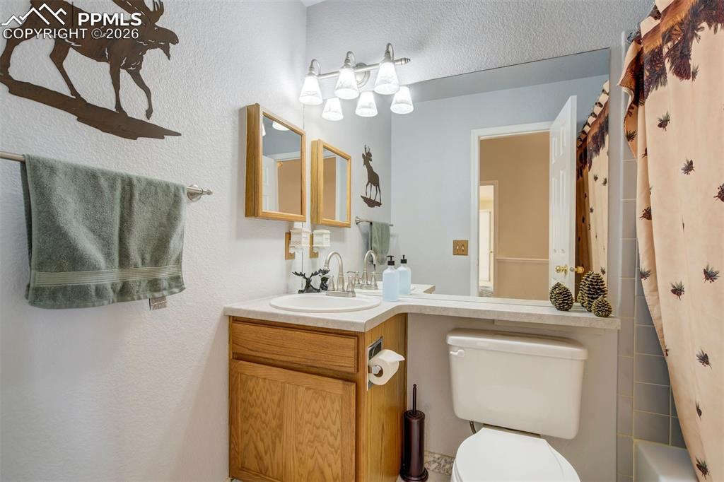 Image 17 of 50: A second full bath offers a spacious vanity, updated lighting, and a practi