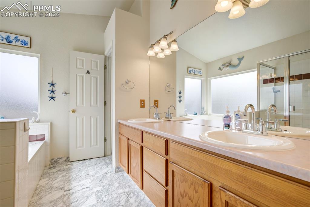 Image 26 of 50: Enjoy a well-appointed bathroom with separate shower and soaking tub, provi