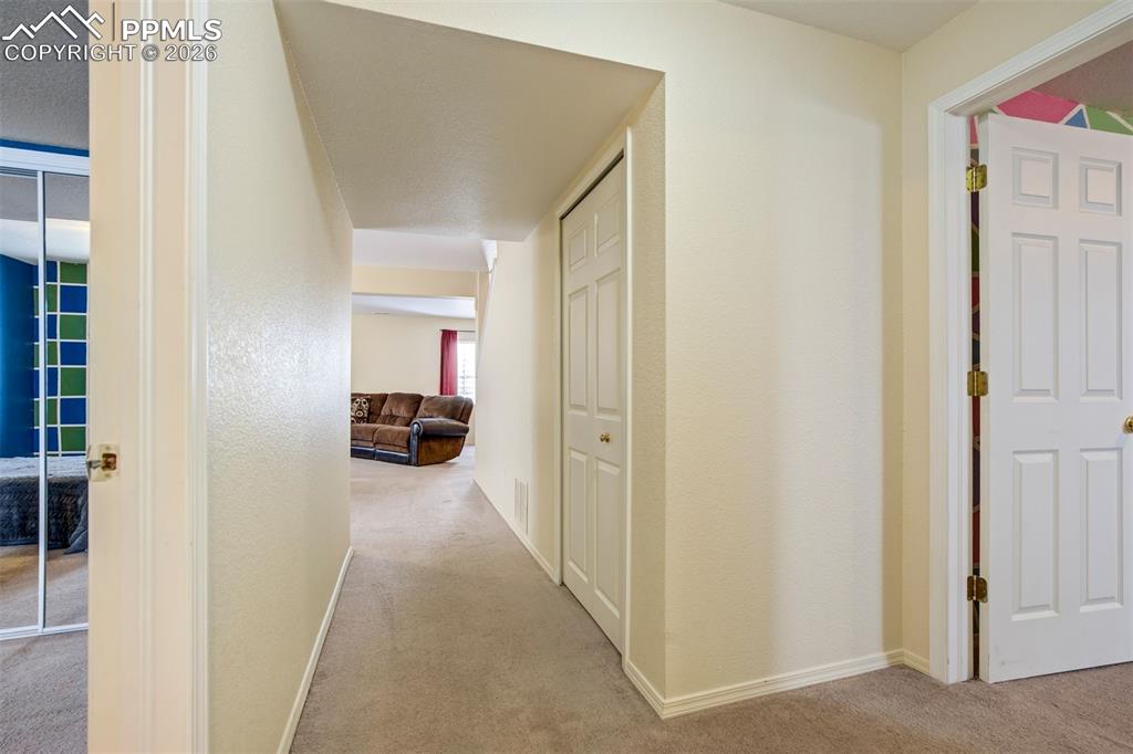 Image 29 of 50: The basement level welcomes you with a clean, neutral hallway offering easy