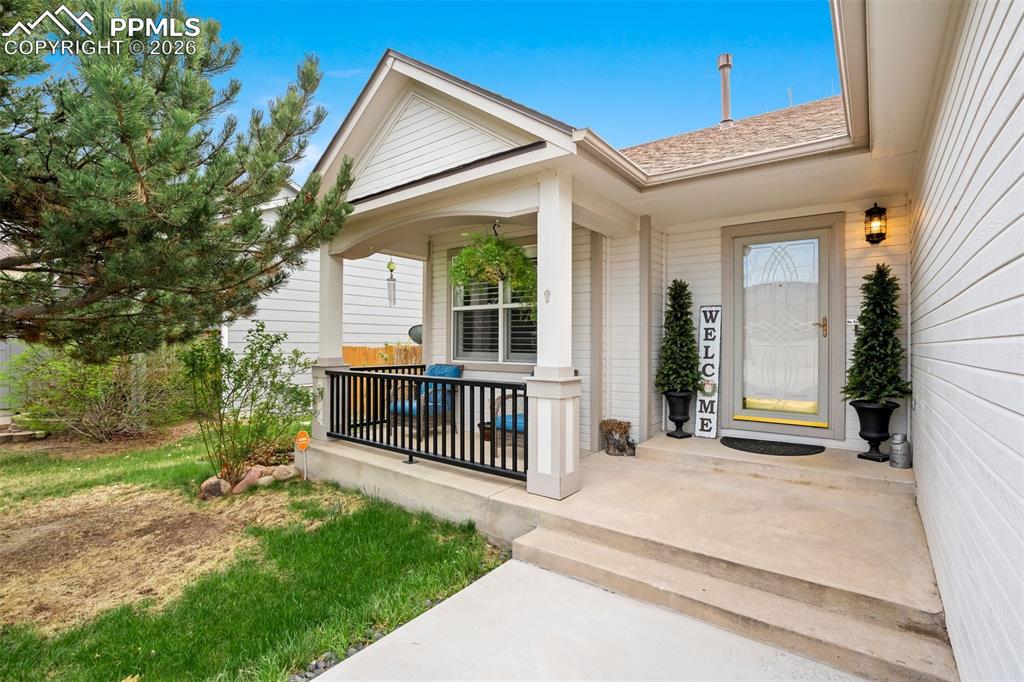 Image 3 of 50: Charming covered front porch with seating area—ideal for relaxing and enjoy