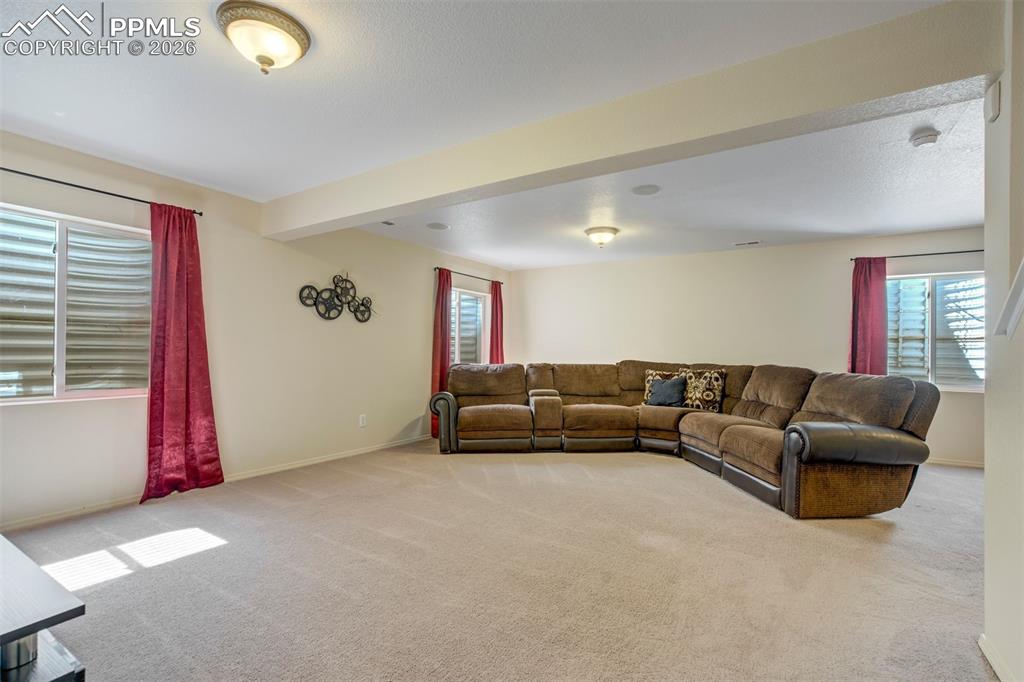 Image 30 of 50: Spacious and versatile, the finished basement offers a large family room pe