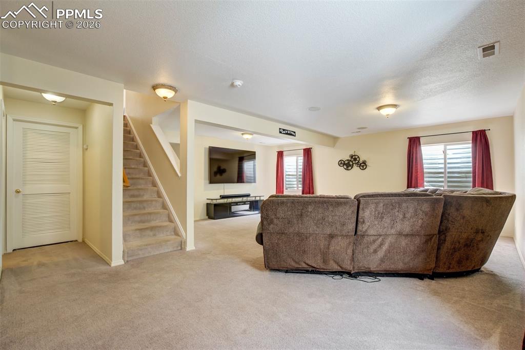 Image 33 of 50: Convenient stair access connects the basement to the main level, with an op