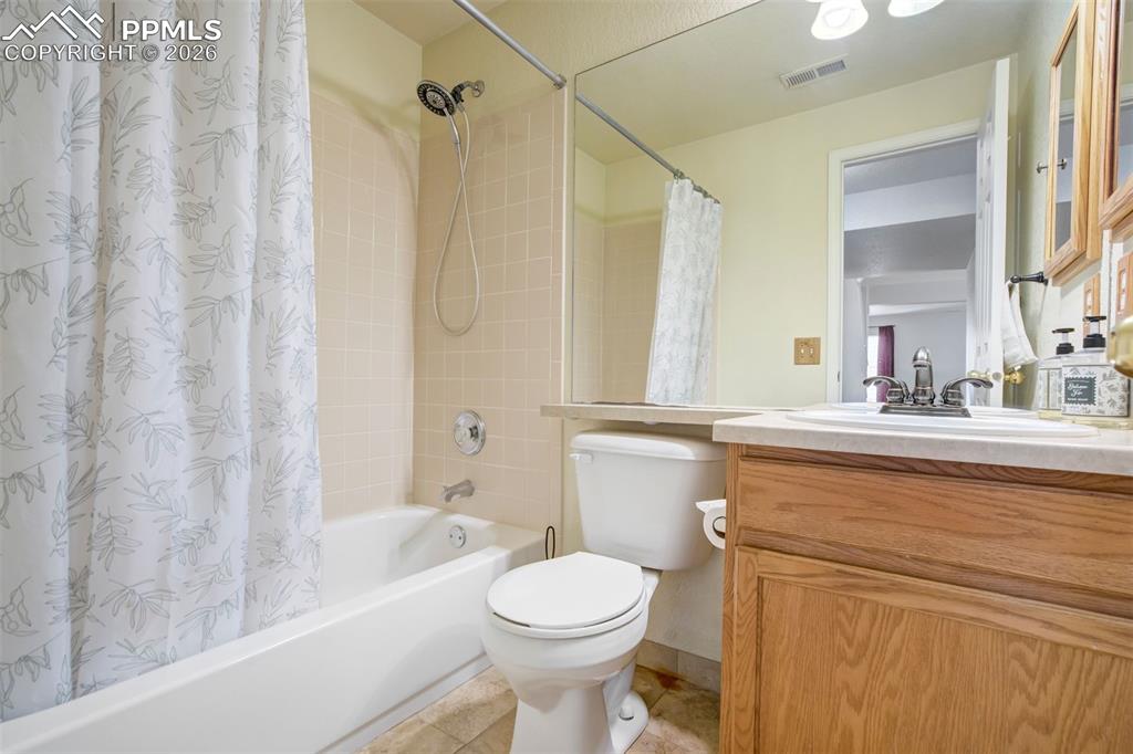 Image 40 of 50: Clean and functional, this full bathroom features a tub/shower combo, exten