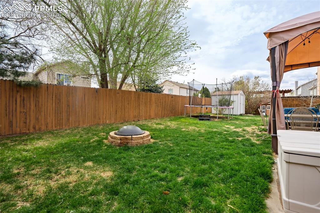 Image 46 of 50: Enjoy outdoor evenings around the dedicated fire pit area, perfect for gath