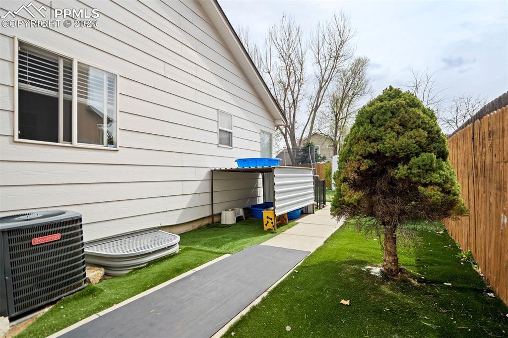 Image 48 of 50: A thoughtfully designed side yard offers a dedicated dog run with low-maint