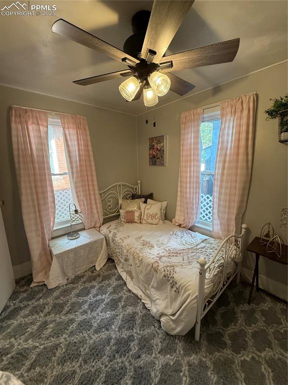 Image 10 of 19: Carpeted bedroom featuring multiple windows and ceiling fan