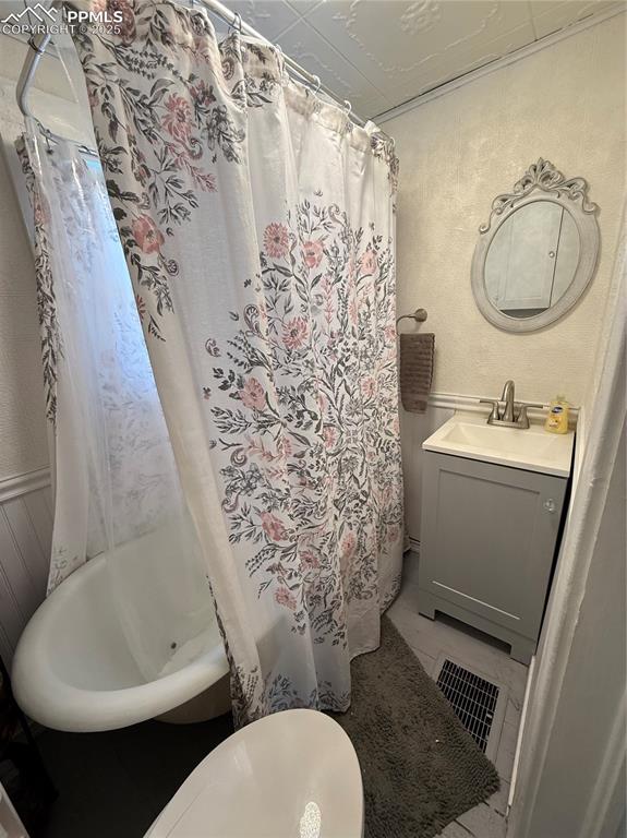 Image 6 of 19: Full bath featuring a vanity, and shower / bathtub combination with curtain