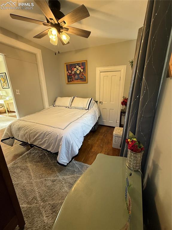Image 8 of 19: Bedroom featuring dark wood-type flooring and ceiling fan