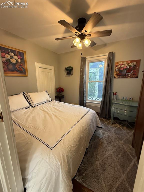 Image 9 of 19: Bedroom featuring dark colored carpet and ceiling fan