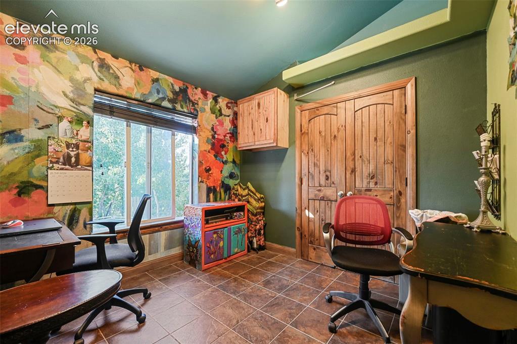 Image 11 of 43: Room featuring wood-finish tile flooring, a window with horizontal blinds,