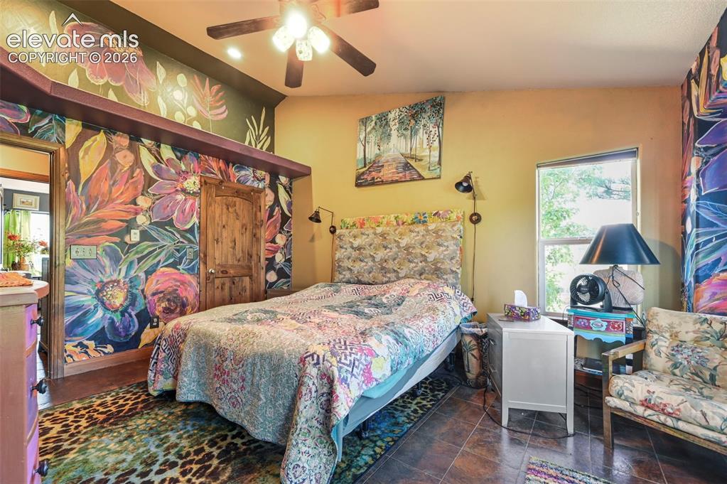 Image 15 of 43: Bedroom featuring tile flooring, a window with natural light, a wood-finish