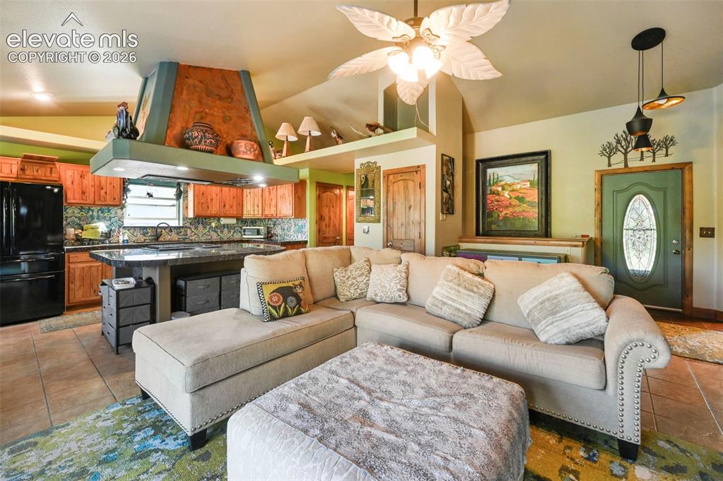 Image 4 of 43: Open-concept living area with vaulted ceilings