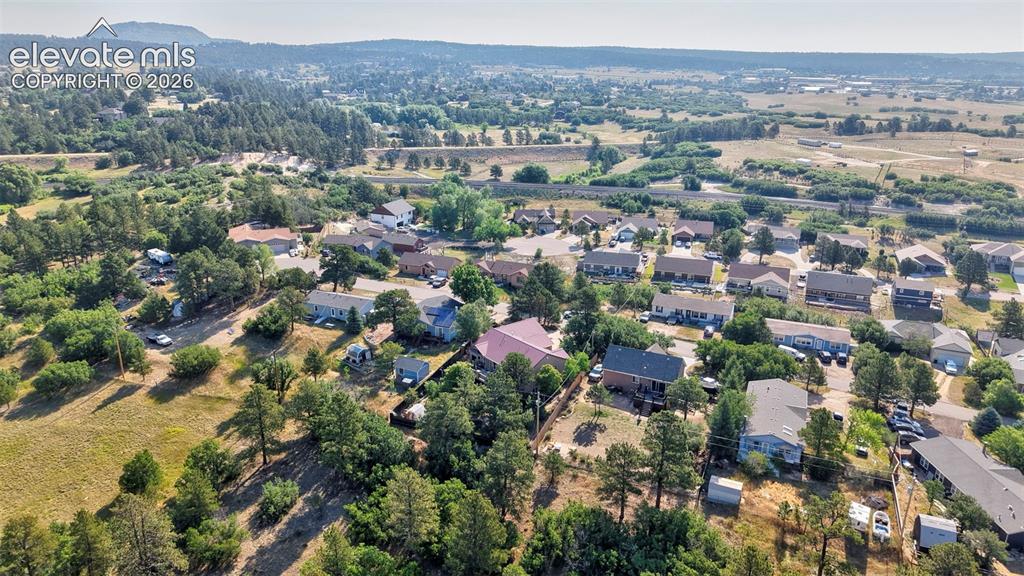 Image 40 of 43: Aerial view showcasing a residential area amidst a landscape of mature tree
