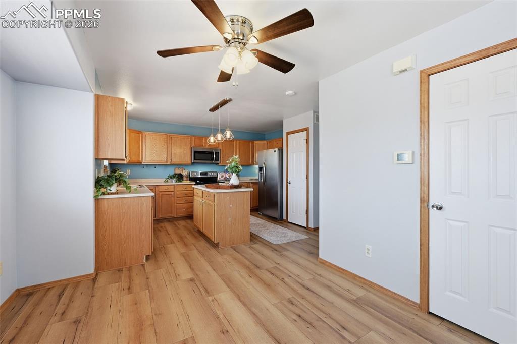 Image 10 of 42: Dining are looking into the kitchen, coat closet on right of picture, pantr